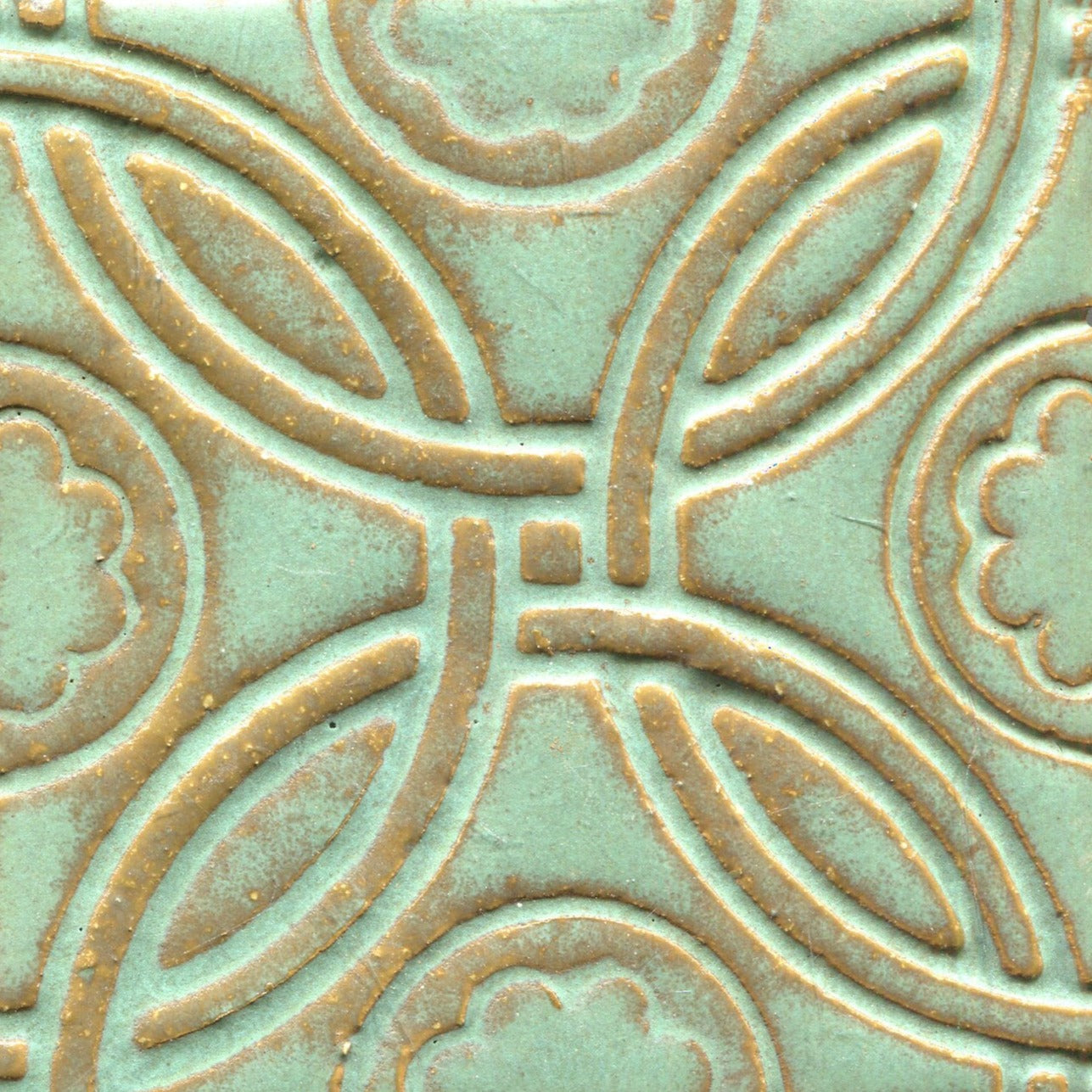 A Celtic inspired geometric pattern on stamped tiles in matte green