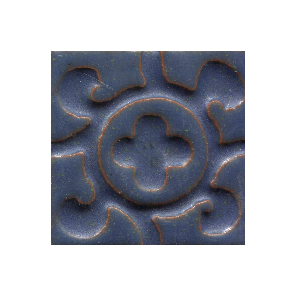 A collection of tiles featuring a stamped clover pattern in Blueberry