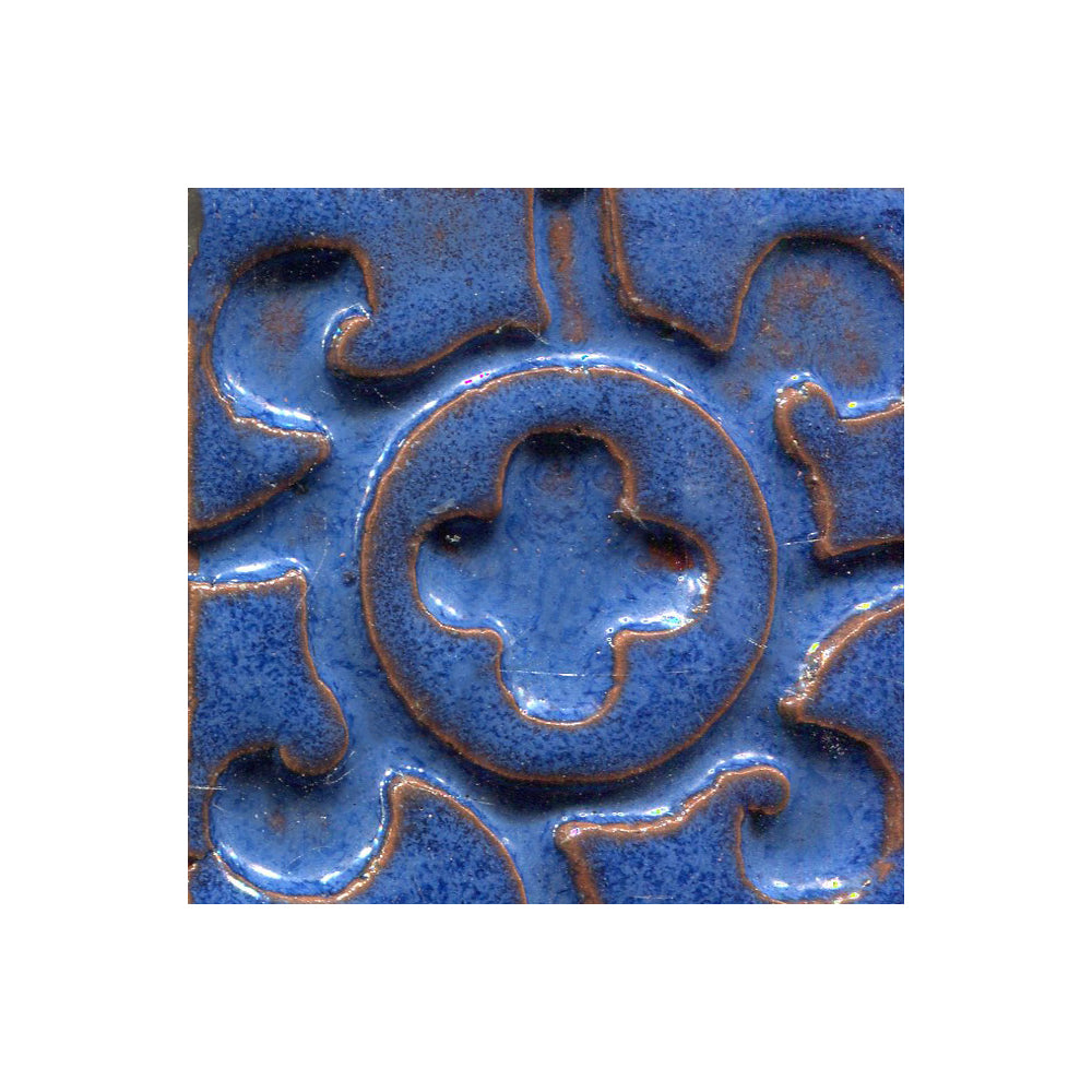 A collection of tiles featuring a stamped clover pattern in Cobalt Blue