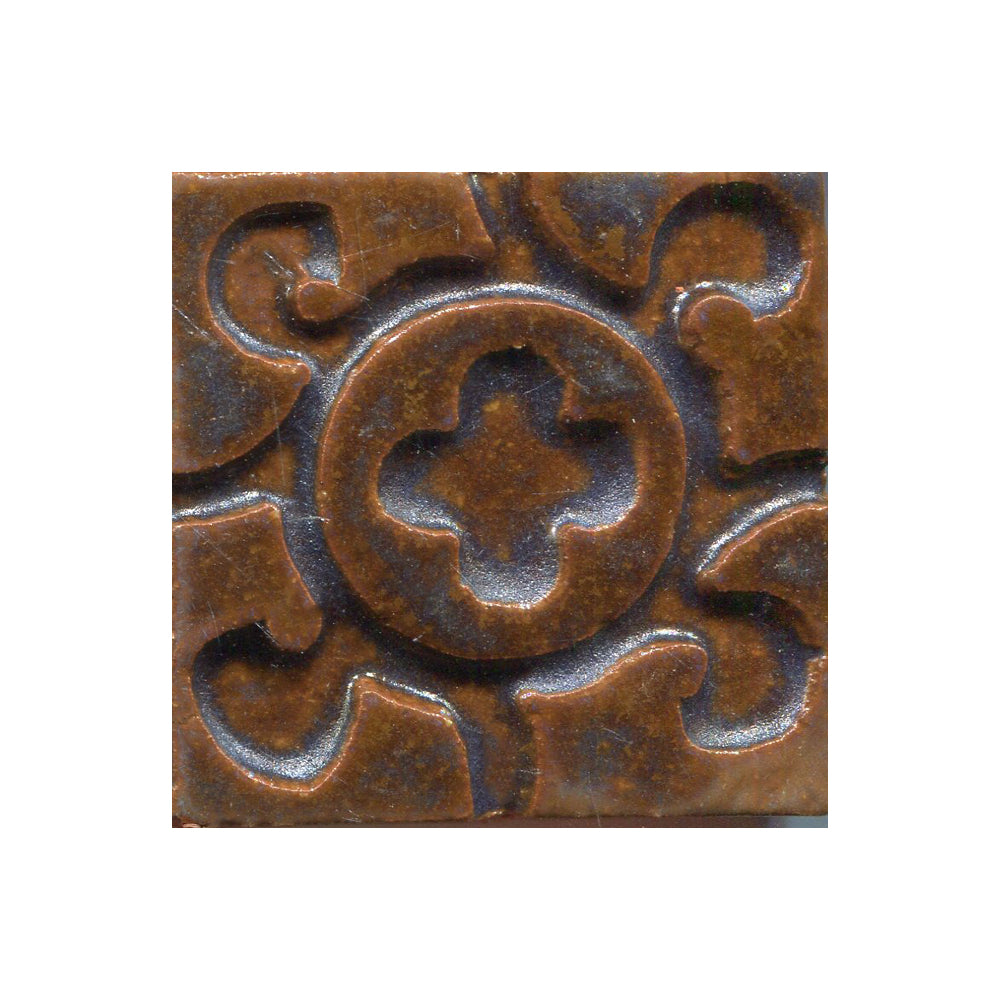 A collection of tiles featuring a stamped clover pattern in Cocomoon bown