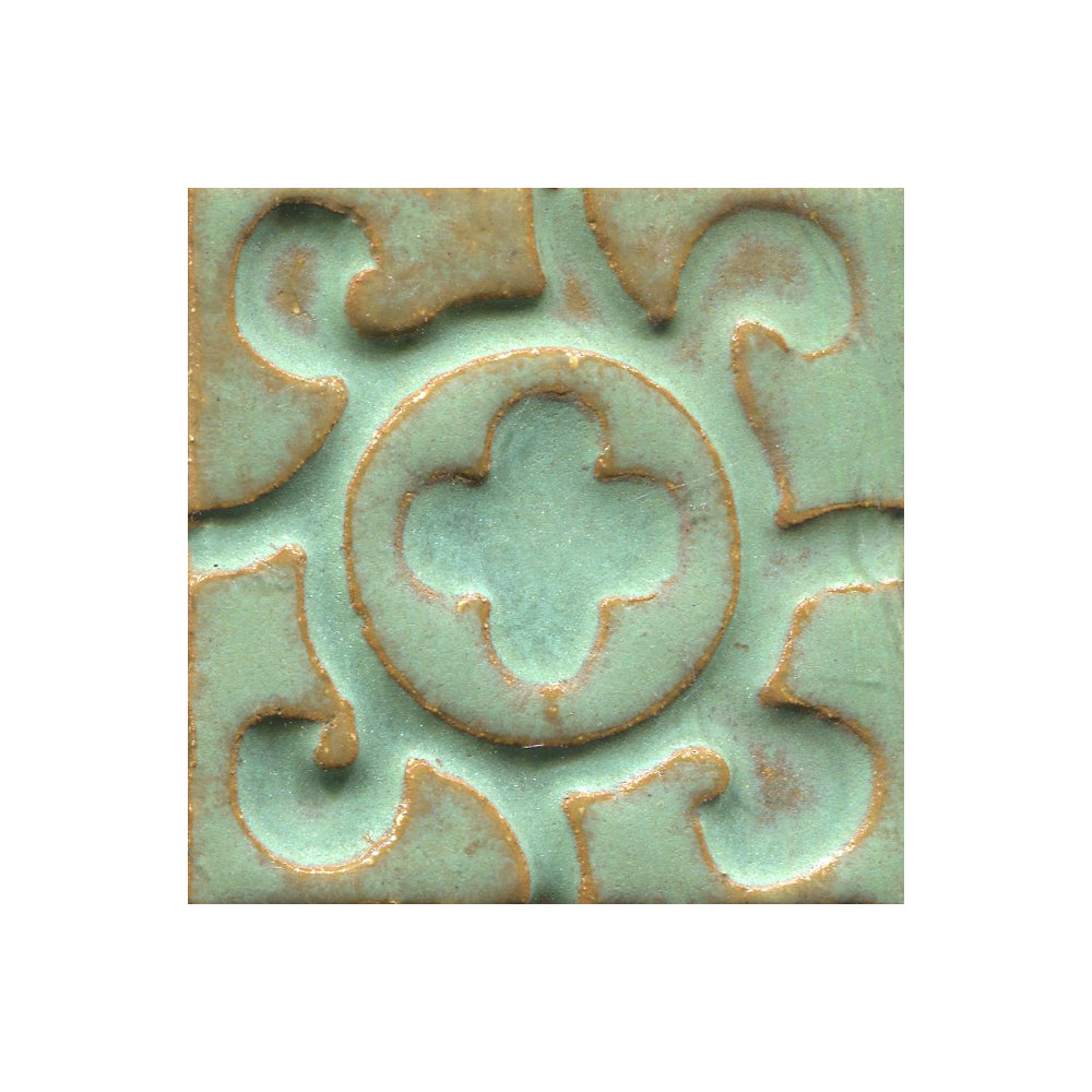 A collection of tiles featuring a stamped clover pattern in Copper patina green