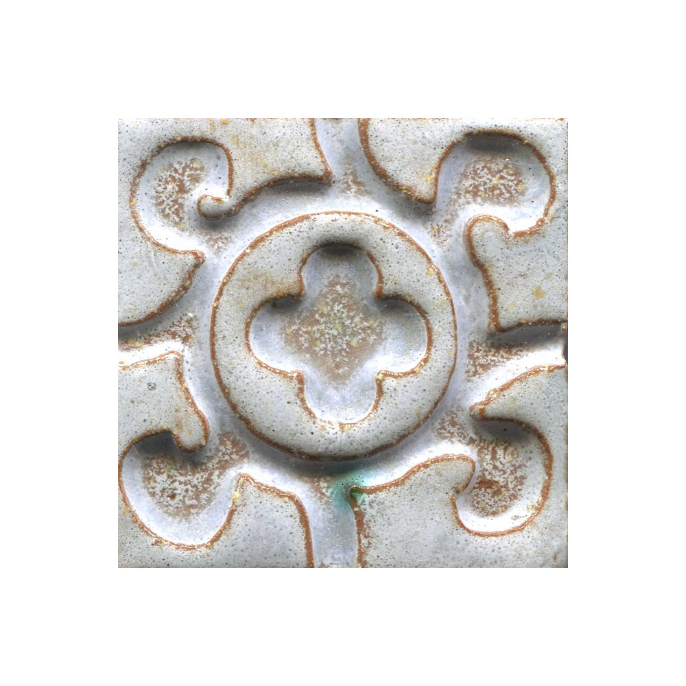 A collection of tiles featuring a stamped clover pattern in grey