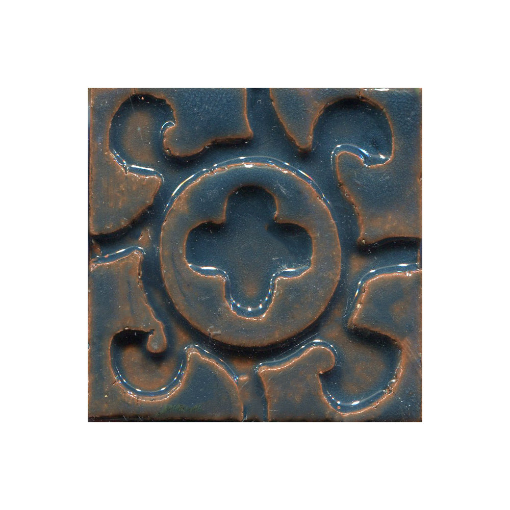 A collection of tiles featuring a stamped clover pattern in Licorice blue