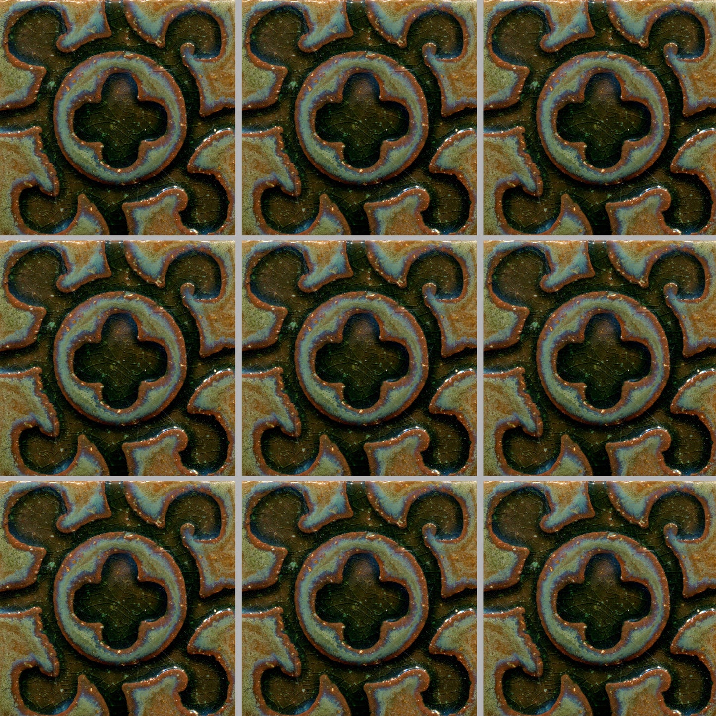 A grid of tiles featuring a stamped design with a floral and geometric pattern in a muted color palette.