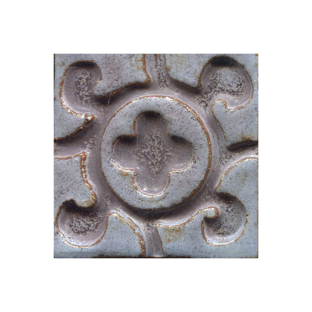 A collection of tiles featuring a stamped clover pattern in oolong grey