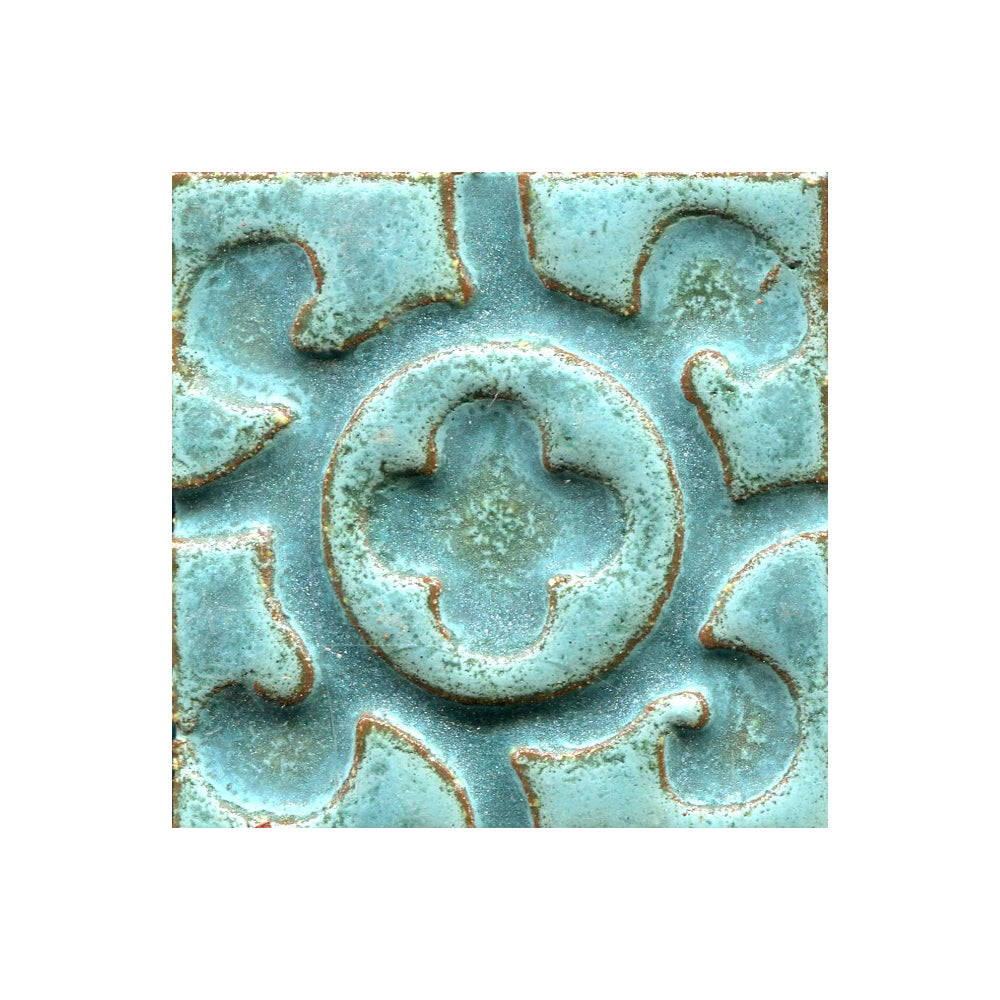 A collection of tiles featuring a stamped clover pattern in matte green