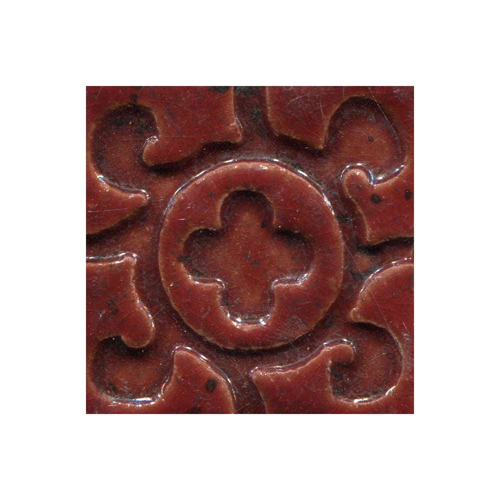 A collection of tiles featuring a stamped clover pattern in strawberry red