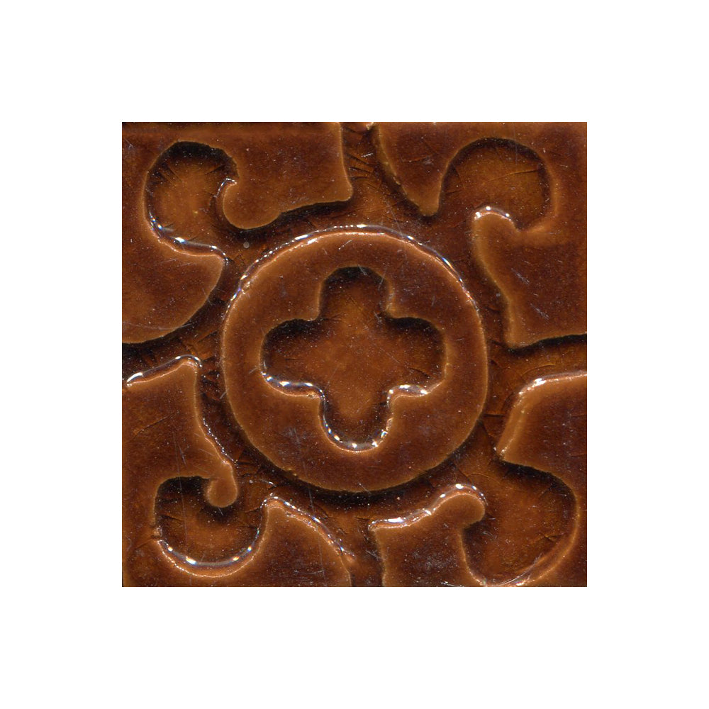 A collection of tiles featuring a stamped clover pattern in toffee brown