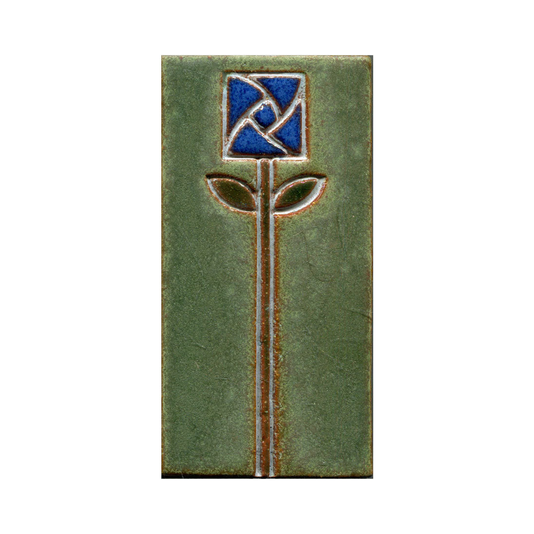 A rectangular ceramic tile with a stamped floral design in the center, featuring blue petals and green leaves