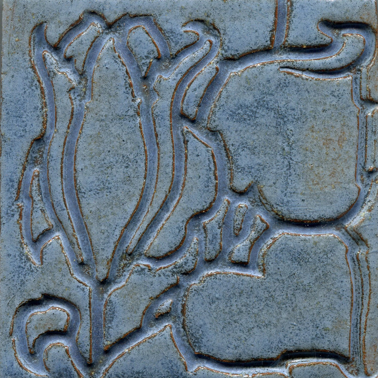 A collection of tiles featuring a stamped floral pattern with tulip designs in blue.