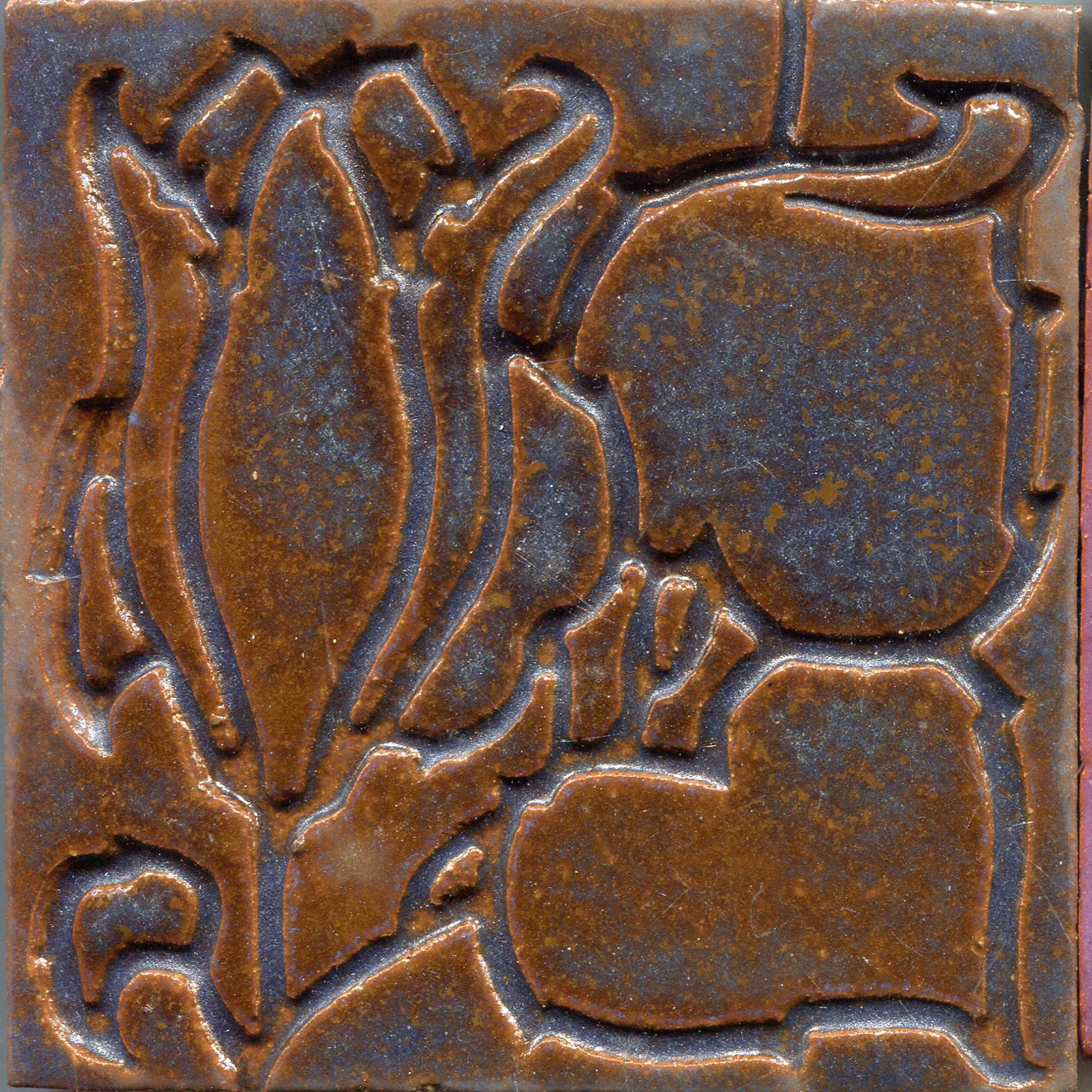 A stamped floral pattern with tulip designs in copper and blue color.