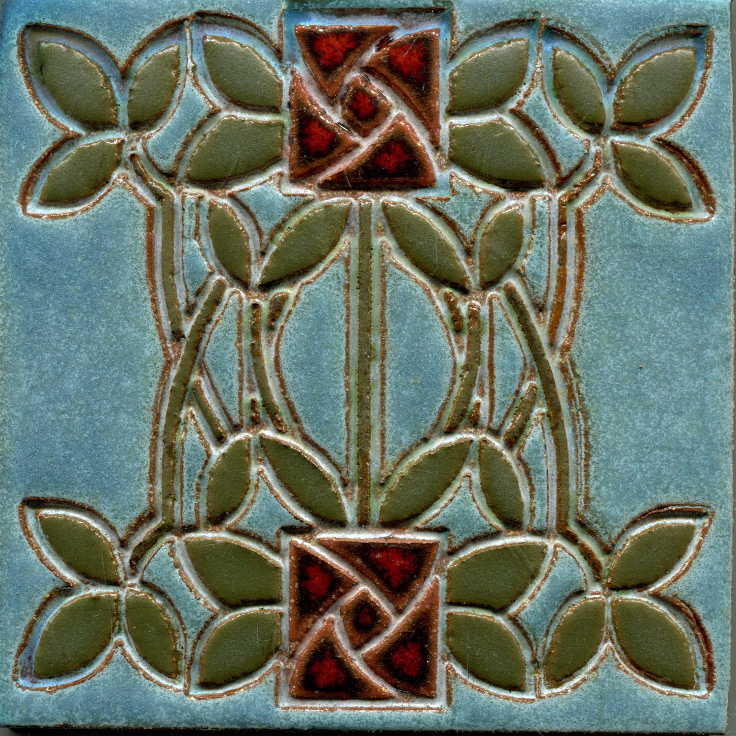 Decorative tile with floral design on a blue background