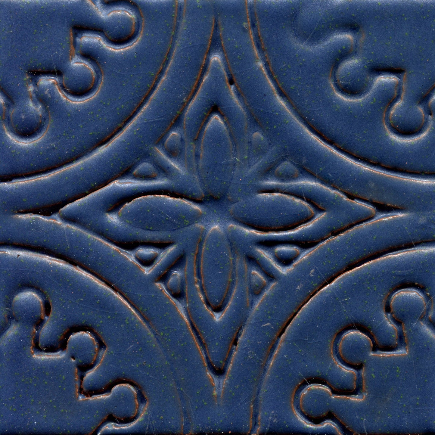 A collection of blue stamped tiles with a floral pattern.