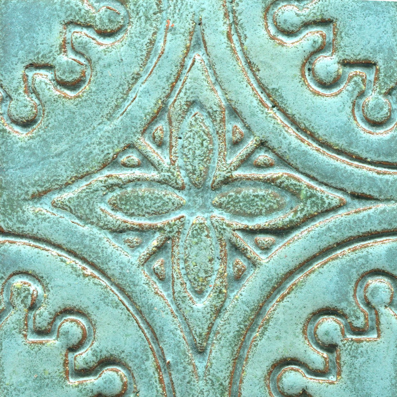 A collection of blue stamped tiles with a floral pattern.
