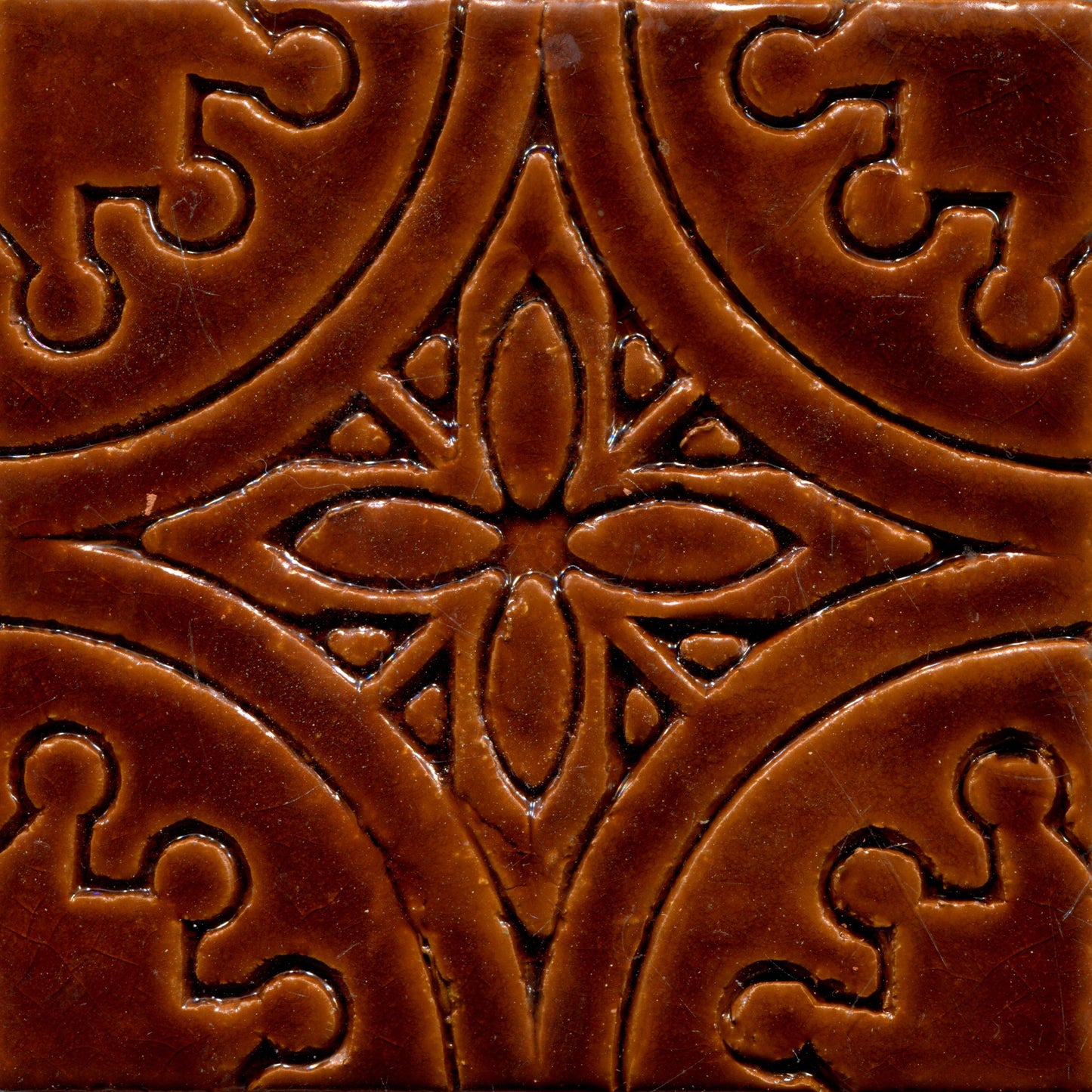 Brown stamped tiles with a floral pattern.