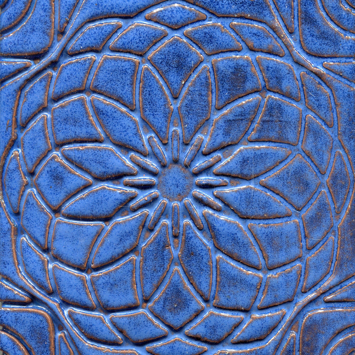 Deep Blue stamped tile with a geometric floral pattern.