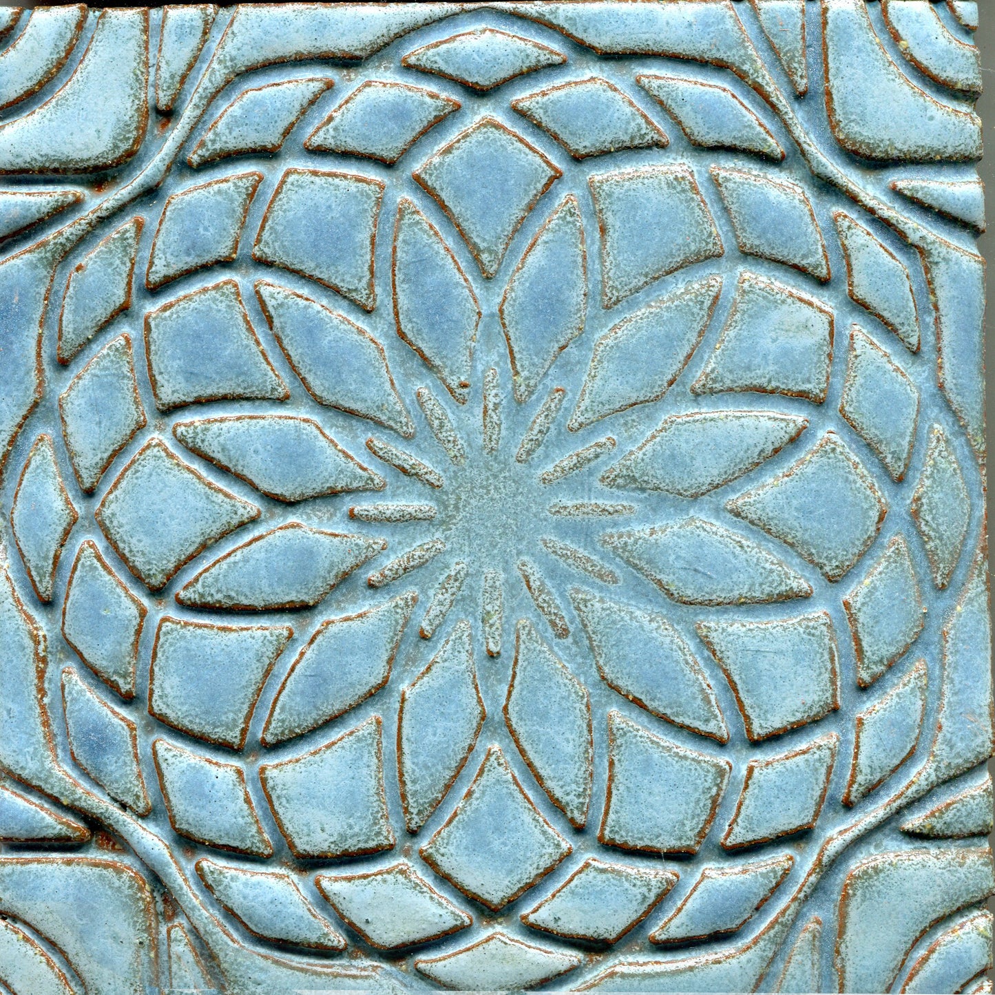 Light Blue stamped tile with a geometric floral pattern.