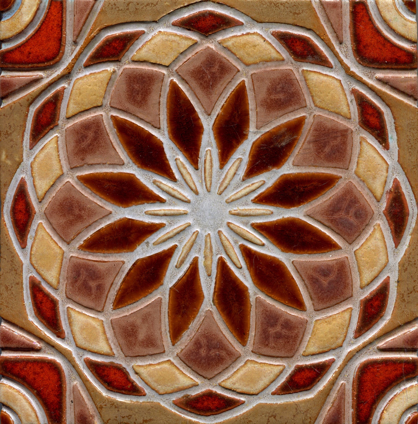 brown and yellow stamped tile with a geometric floral pattern.