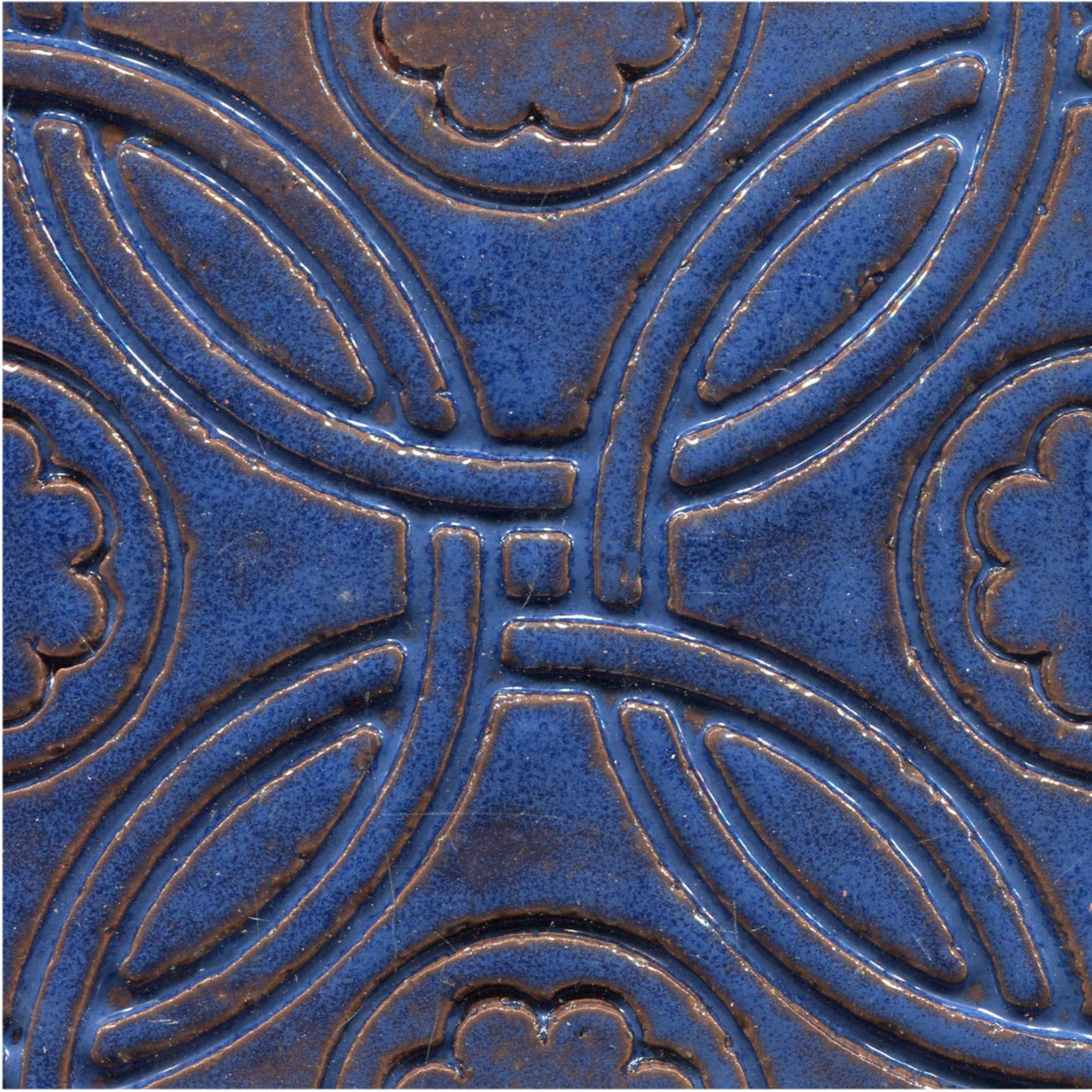 A Celtic inspired geometric pattern on stamped tiles in deep blue