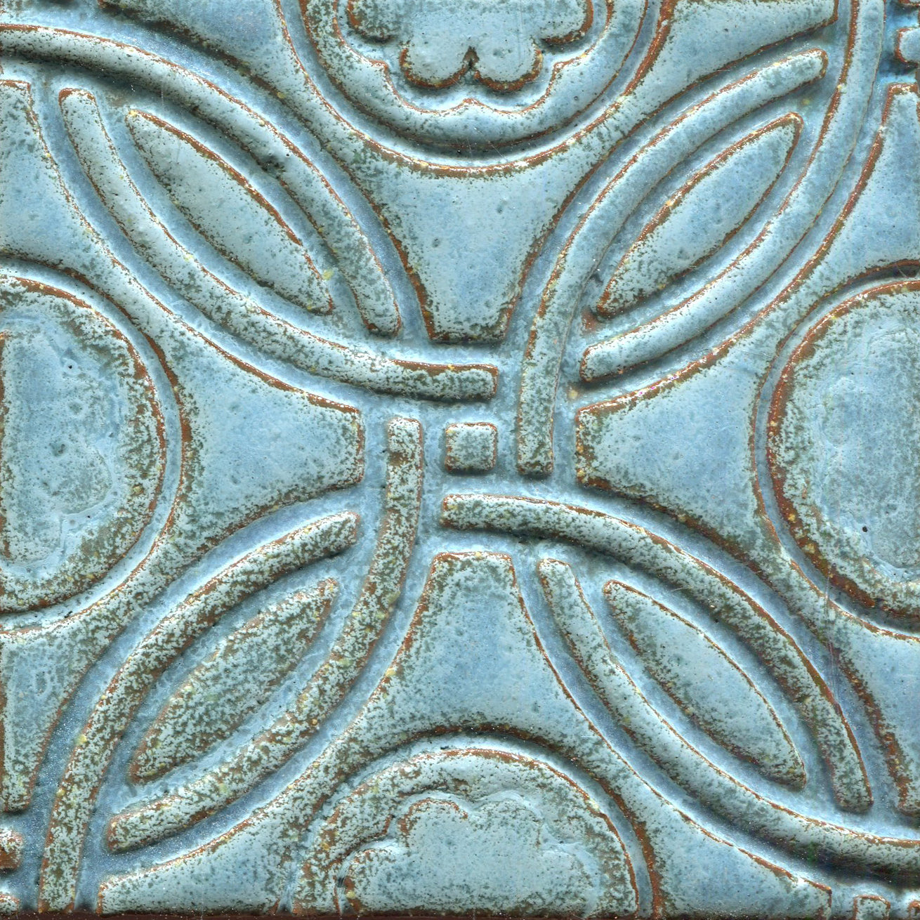 A Celtic inspired geometric pattern on stamped tiles in aqua blue