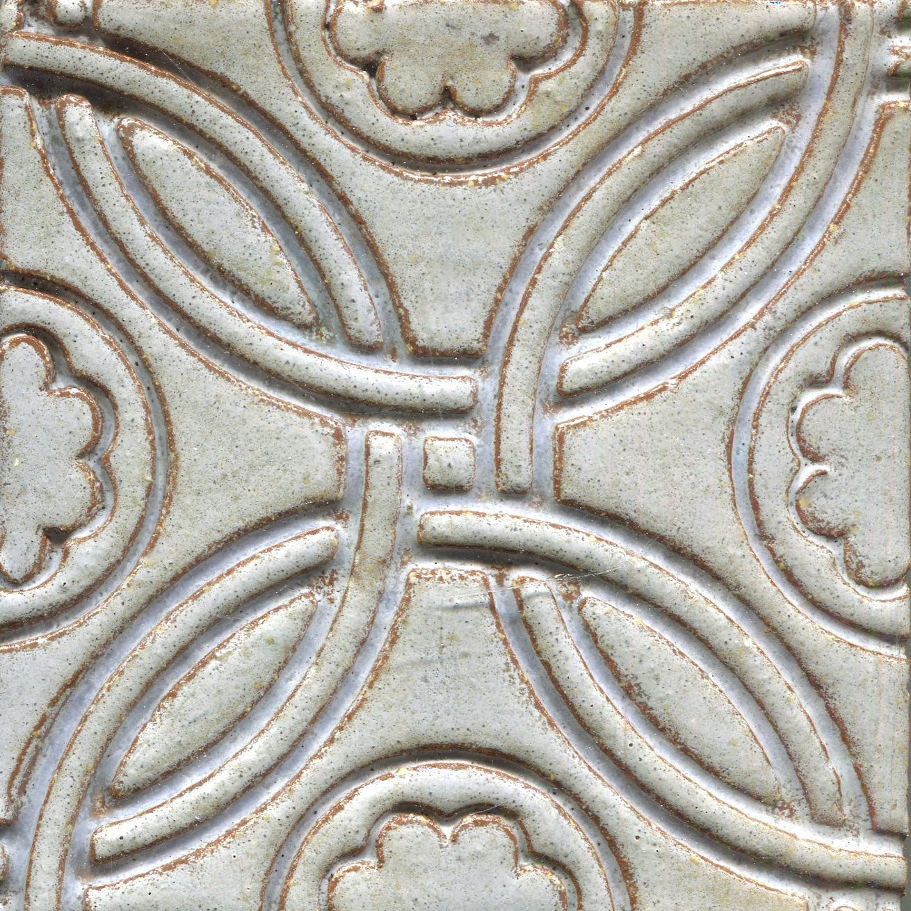 A Celtic inspired geometric pattern on stamped tiles in light grey