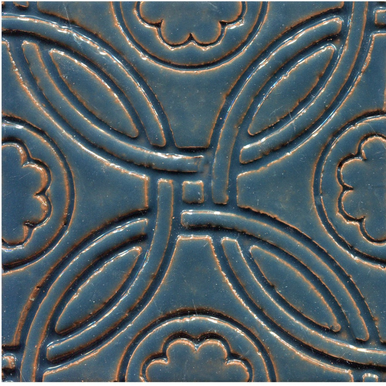 A Celtic inspired geometric pattern on stamped tiles in blue