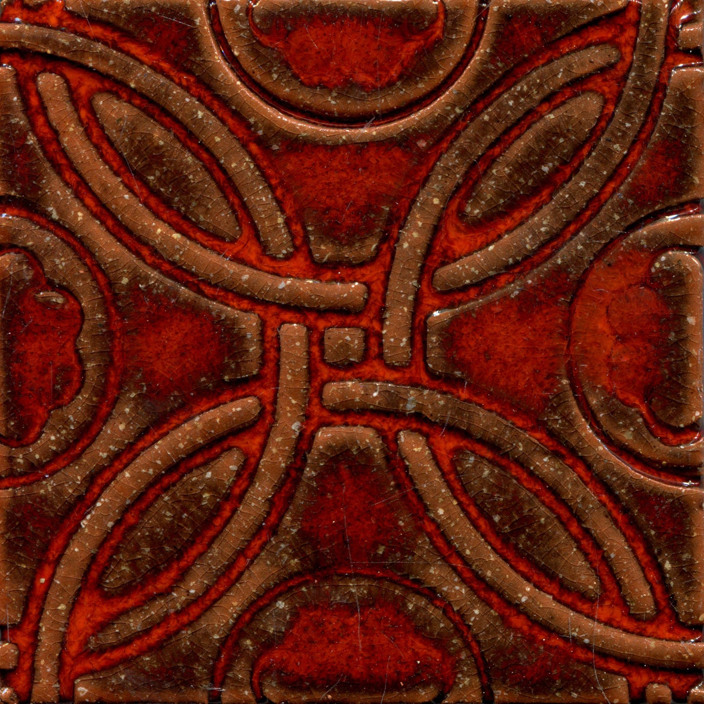 A Celtic inspired geometric pattern on stamped tiles in orange