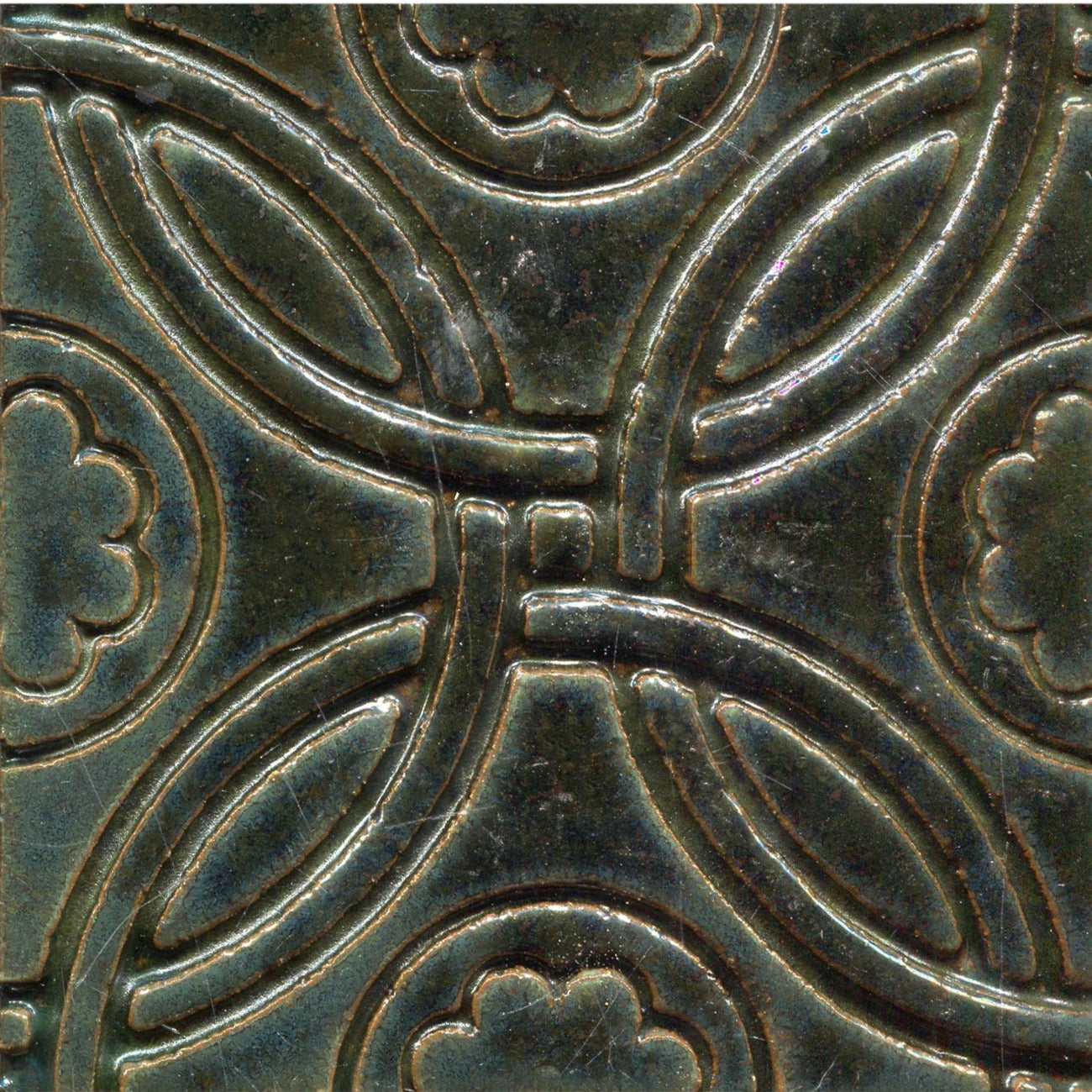 A Celtic inspired geometric pattern on stamped tiles in various colors.