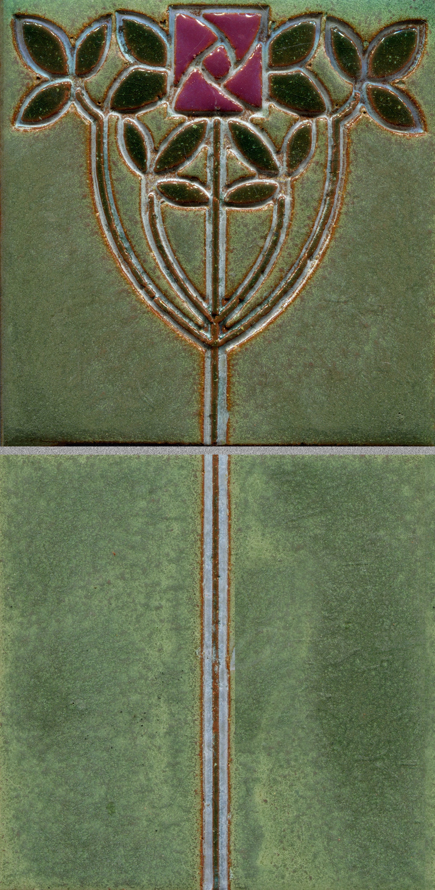 A stamped tile featuring a floral Art Nouveau design with intertwined stems and vibrant, multicolored petals on a green background.