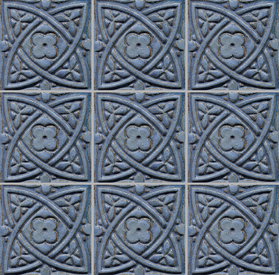A collection of blue stamped tiles with a Celtic geometric pattern.
