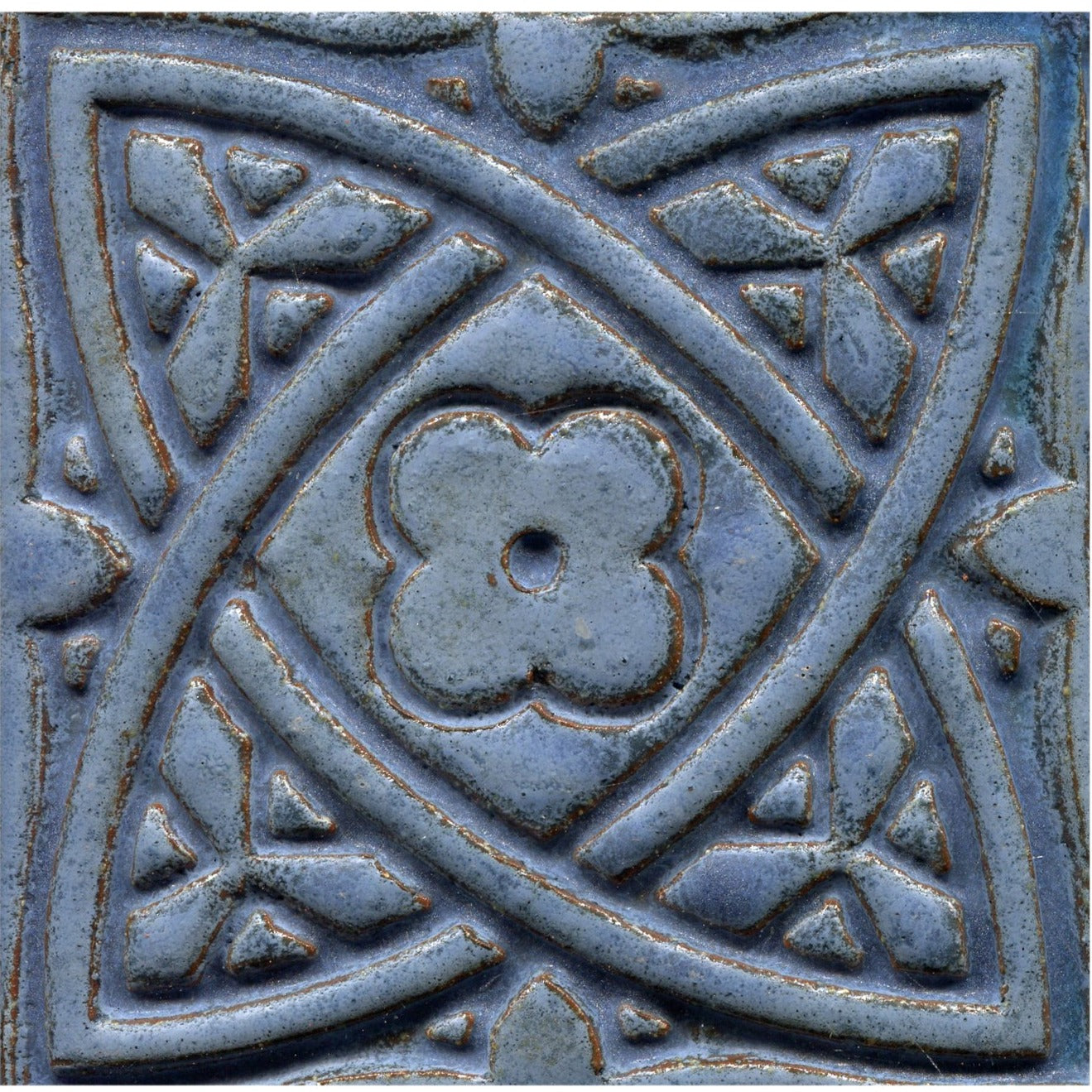 Blue stamped tiles with a Celtic geometric pattern.