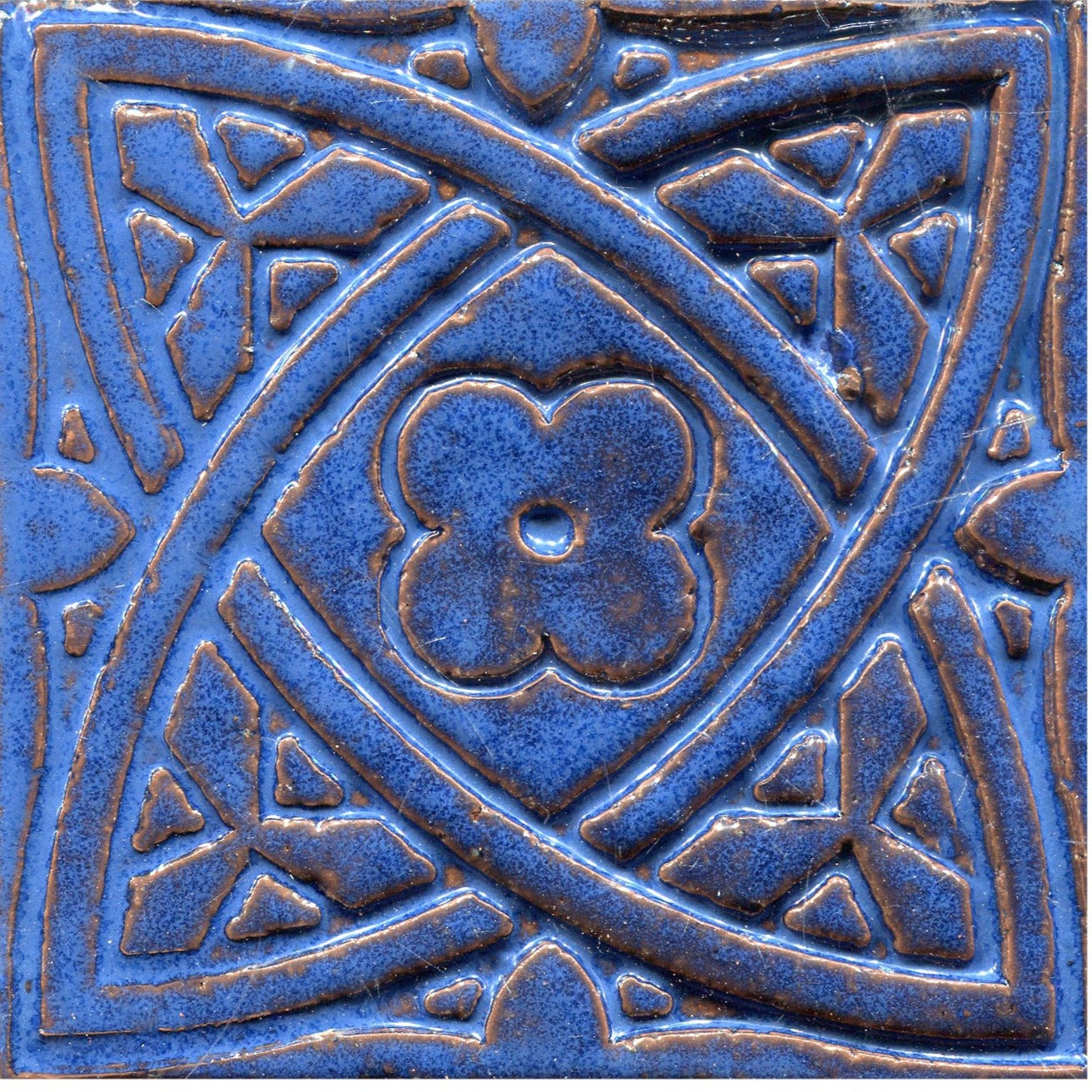 Blue stamped tiles with a Celtic geometric pattern.