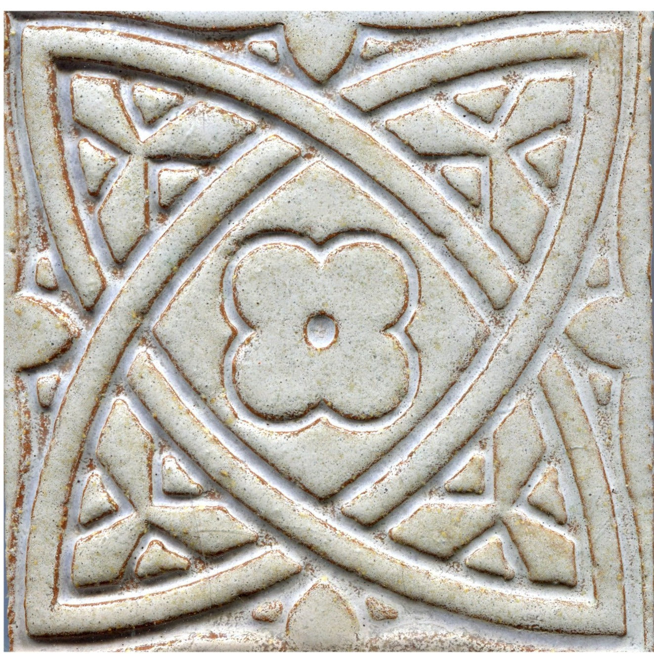 Grey stamped tiles with a Celtic geometric pattern.