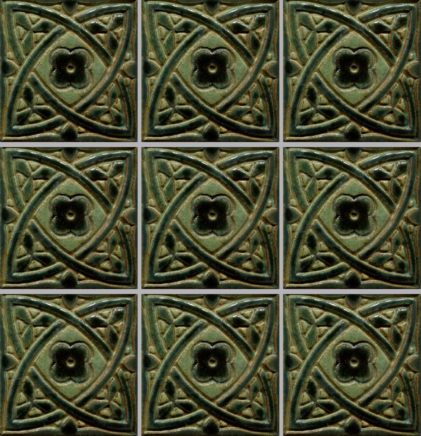 A collection of green stamped tiles with a Celtic geometric pattern.