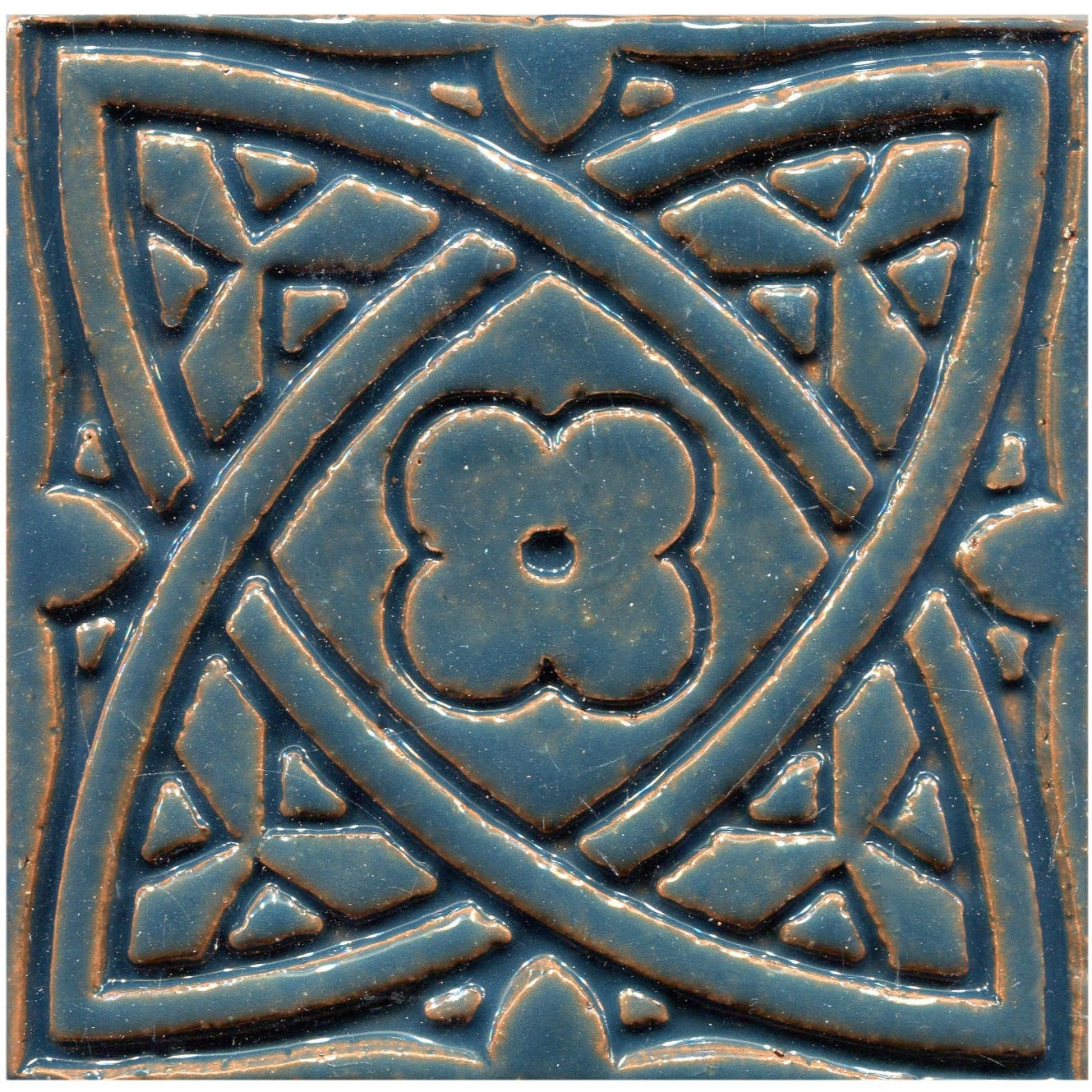Blue stamped tiles with a Celtic geometric pattern.