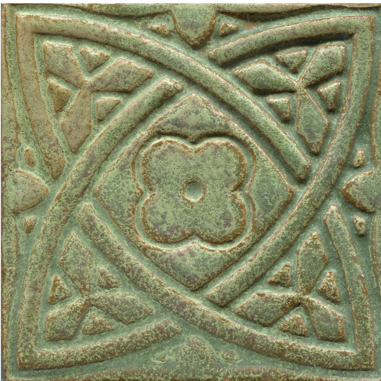 Green stamped tiles with a Celtic geometric pattern.