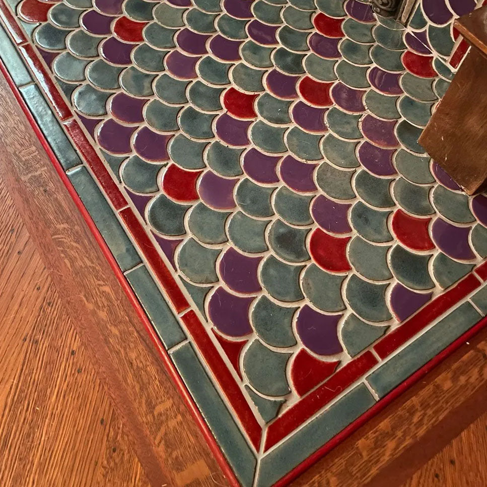 A single line of red ceramic tile trim.