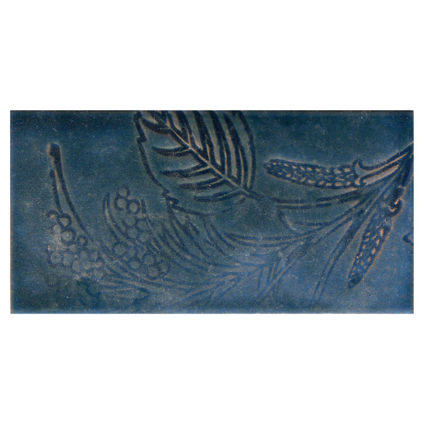 Decorative tile with embossed design on a blue background