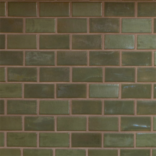 subway pattern of Pesto green tiled wall featuring a running bond pattern.