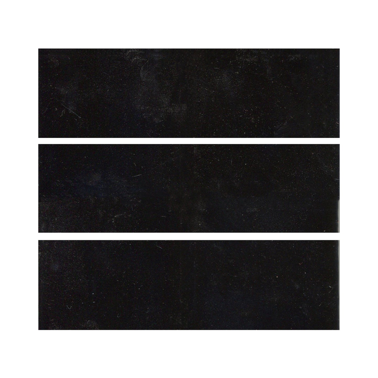 Black glazed ceramic tiles showing a gloss black color with hints of blue.