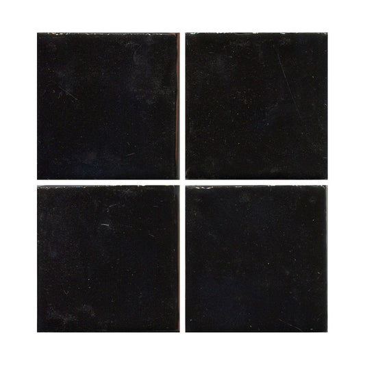 Four black ceramic tiles arranged in a 2x2 grid, showing a gloss black color with hints of blue.