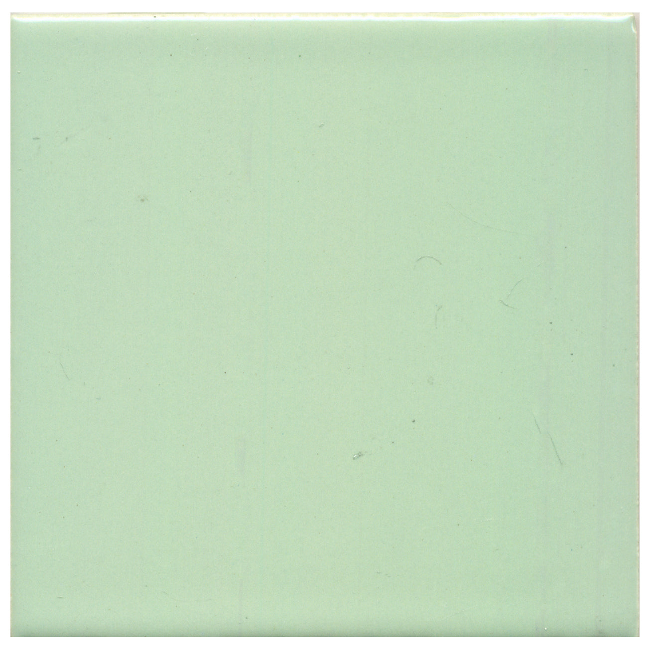 A single light green ceramic tile with a opaque gloss finish.