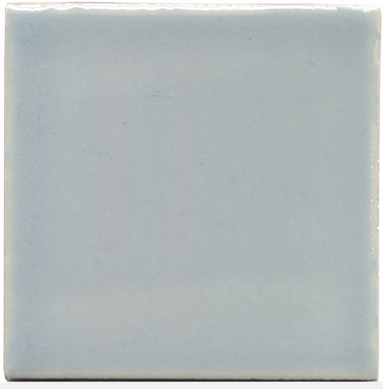 A single square ceramic tile with a light gray-blue color.