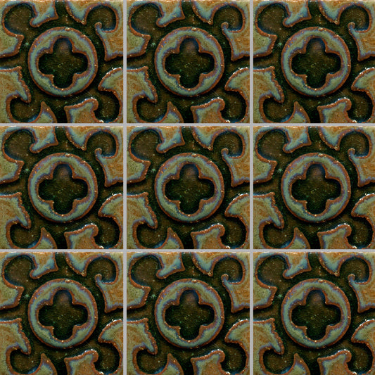 A grid of tiles featuring a stamped design with a floral and geometric pattern in a muted color palette.
