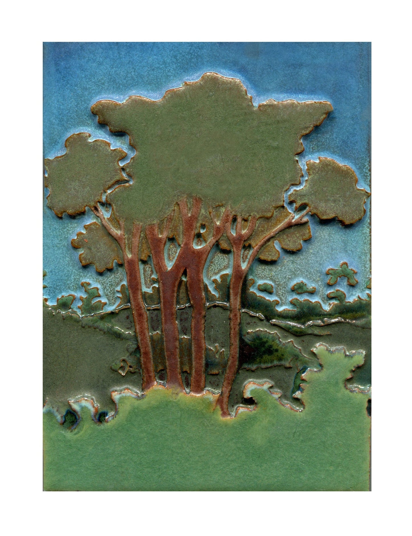 Decorative tile with tree design on a blue and green background