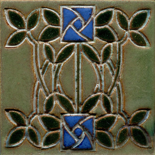 Decorative tile with blue floral design and green leaves 