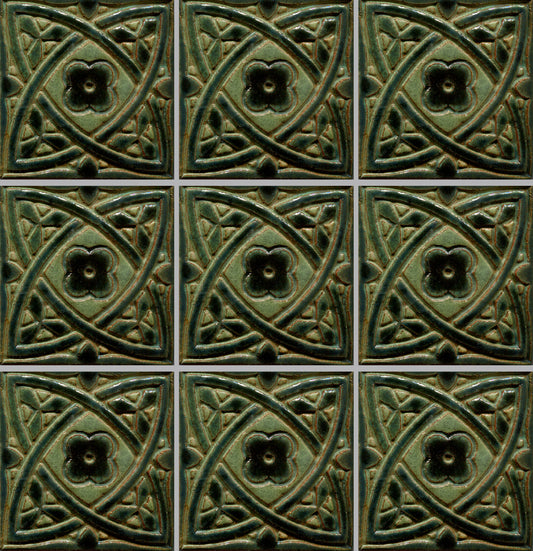 A collection of green stamped tiles with a Celtic geometric pattern.
