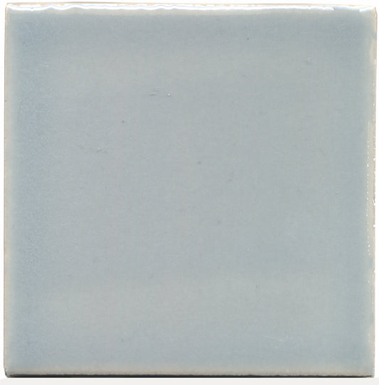 A single square ceramic tile with a light gray-blue color.